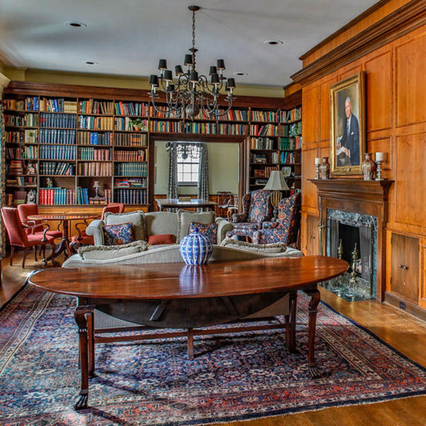 a formal room with walls lined in bookshelves 
